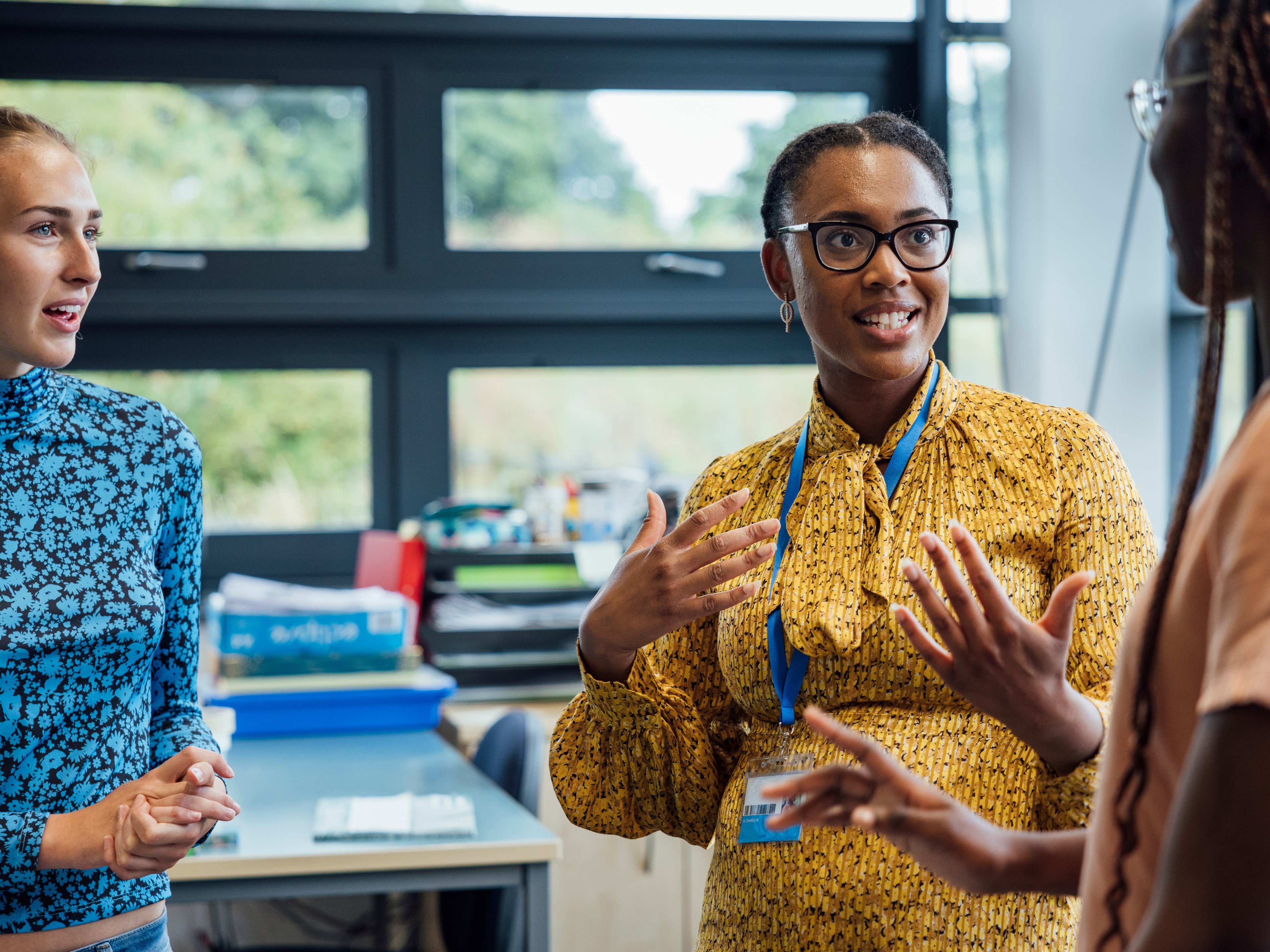 Teachers in a classroom having a discussion
