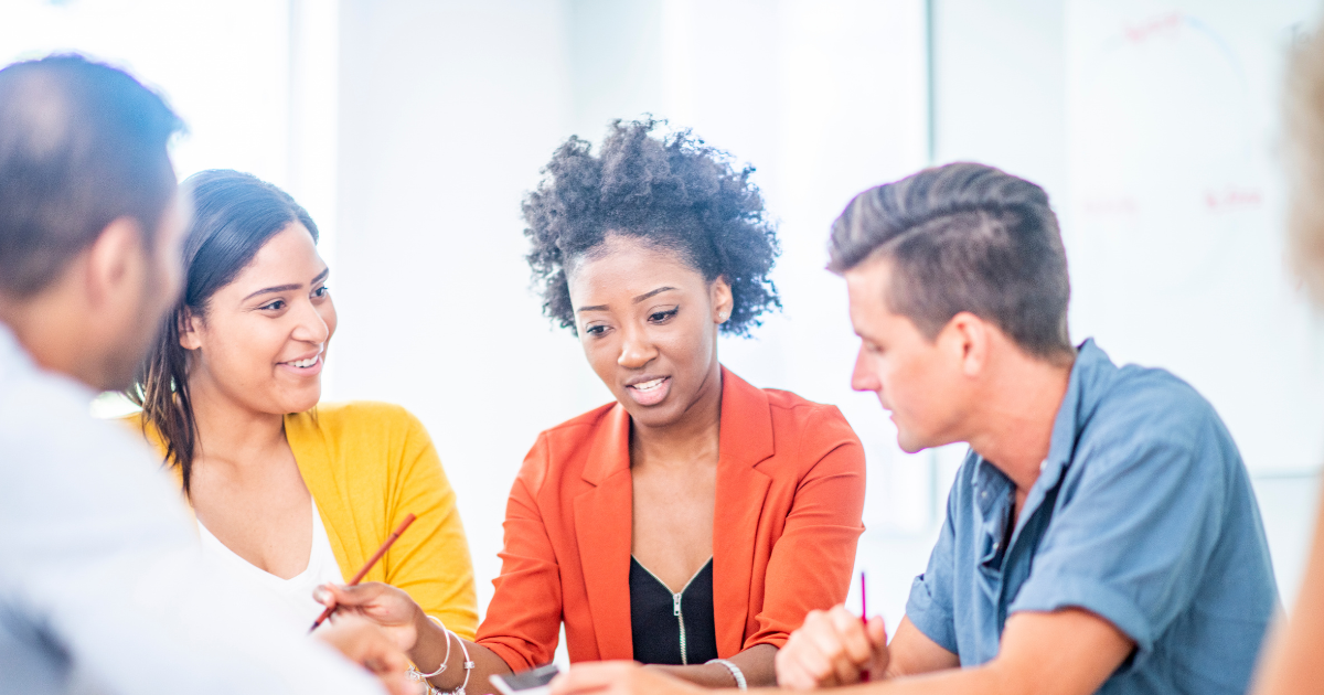 Canva – colleagues at desk discussing agenda