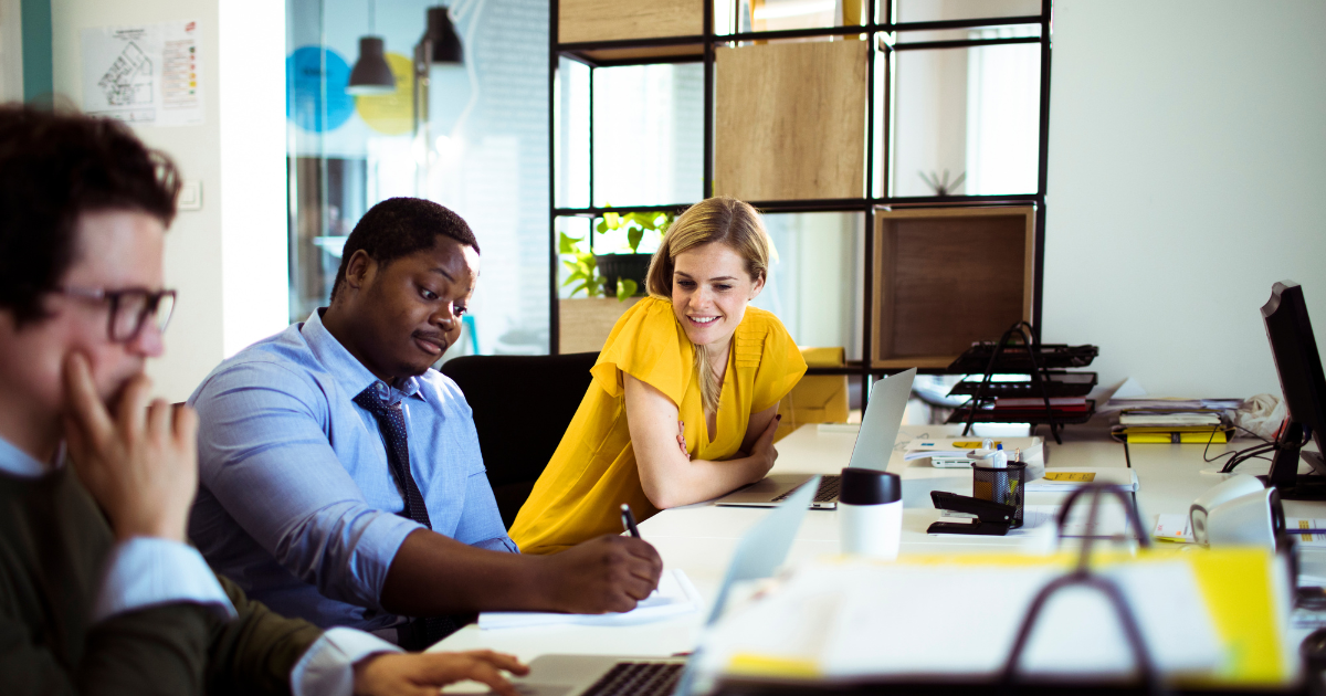 Canva – office workers at desk interacting